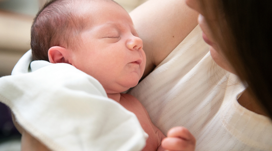Baby Peacefully sleeping in moms arms after sensory play and soothing time with Baby Geometrics