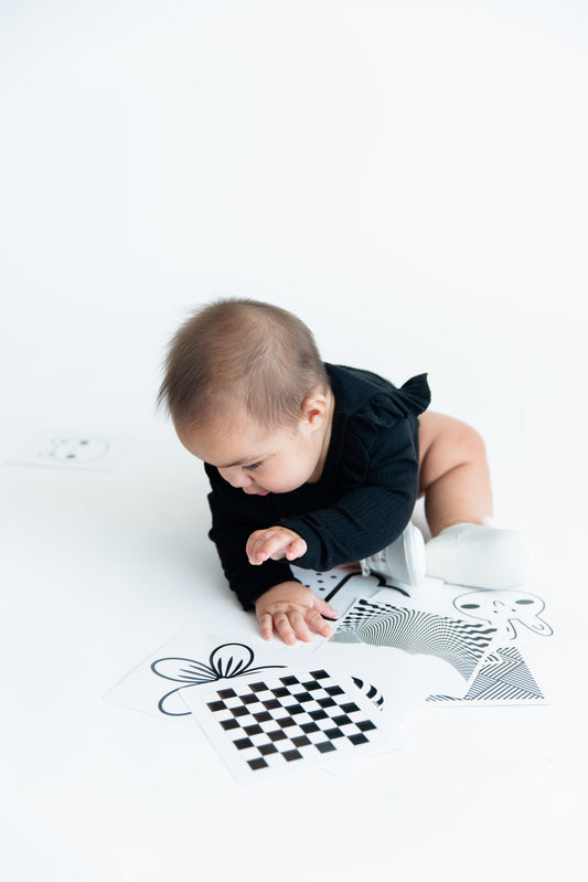 Baby engaged in our high contrast flashcards great for little growing minds