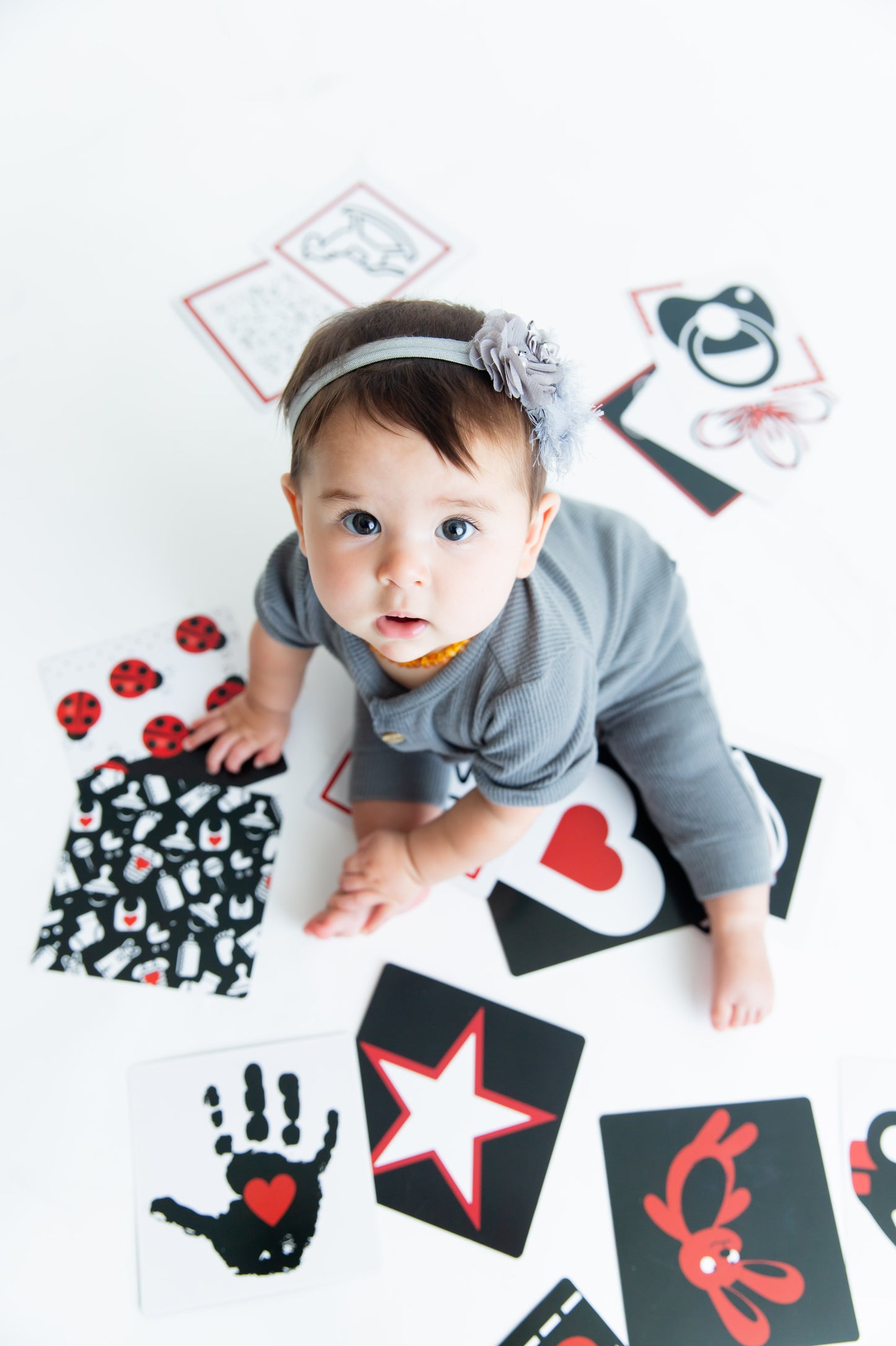 Our little lady is looking up while engaging with Baby Geometrics Flashcards which include high contrast designs for babies development.