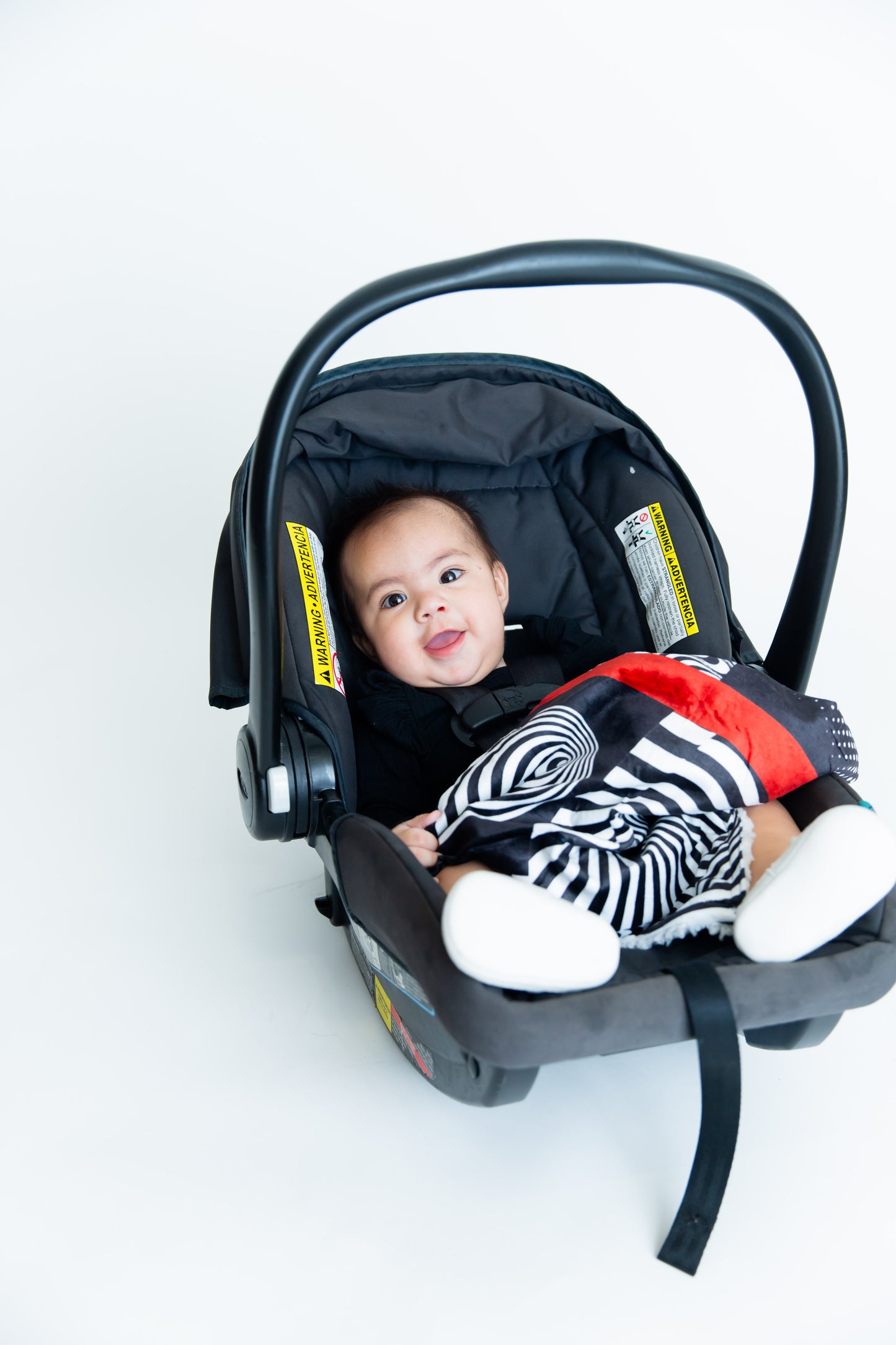 Baby looking cozy and content while enjoying the soft Baby Geometrics high-contrast blanket, designed to provide comfort and stimulate visual and sensory development.