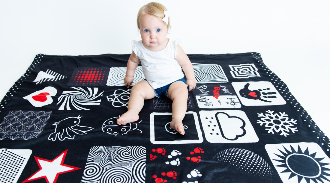 How often should you use a high contrast baby blanket to help sooth a fussy baby, the baby is sitting on our high contrast baby blanket