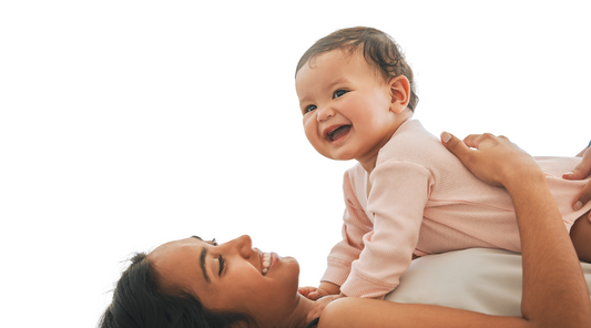 Baby with Mama during tummy time, baby geometrics explains how tummy time with high contrast images will hold the focus of the baby longer and therefore build stronger neck and back muscles. 
