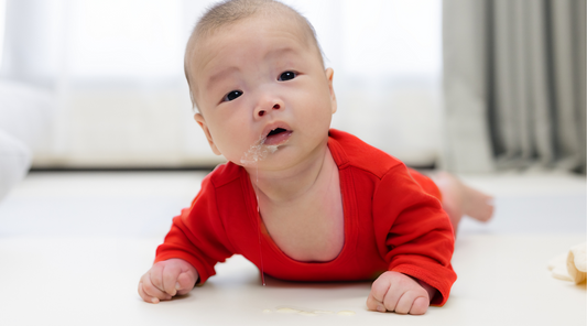 Baby Geometrics baby with spit up and why a baby high contrast blanket is best for tummy time. 
