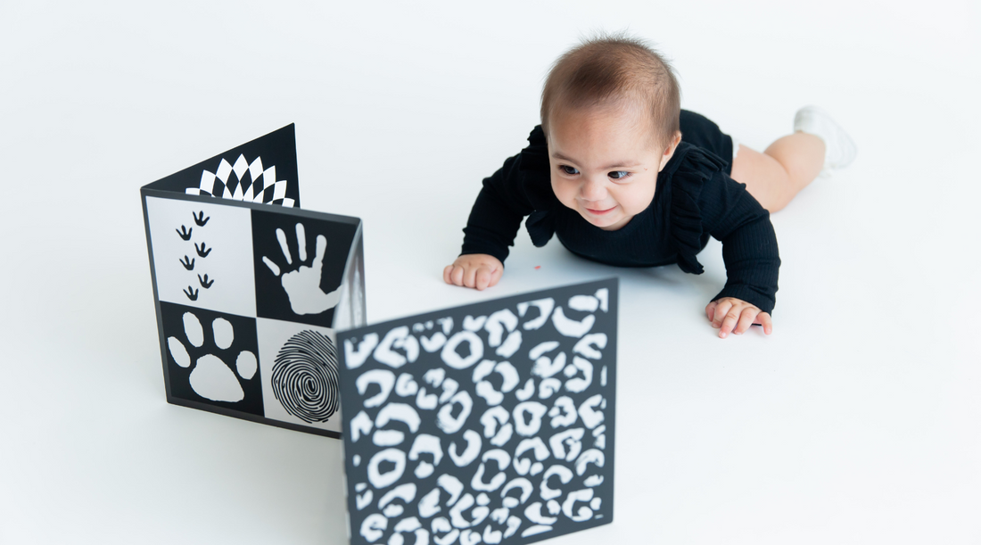 Baby model looking at high contrast baby vision board for brain development