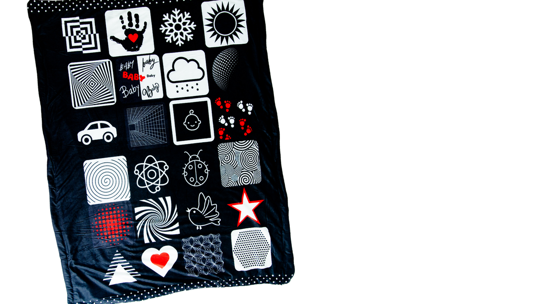 High-contrast red, black, and white baby blanket from Baby Geometrics, designed to support sensory and cognitive development during tummy time and early play.