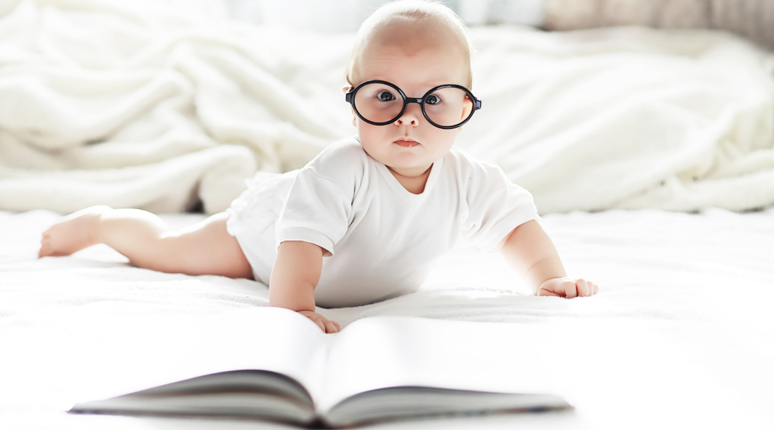 Baby exploring a high-contrast Baby Geometrics flashcard book, illustrating the connection between visual play and early literacy development.