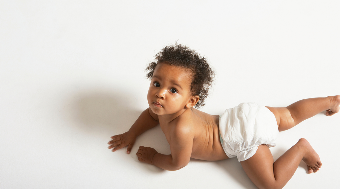 Baby in diapers looking up at camera the perfect little guy to use high contrast toys during diaper time