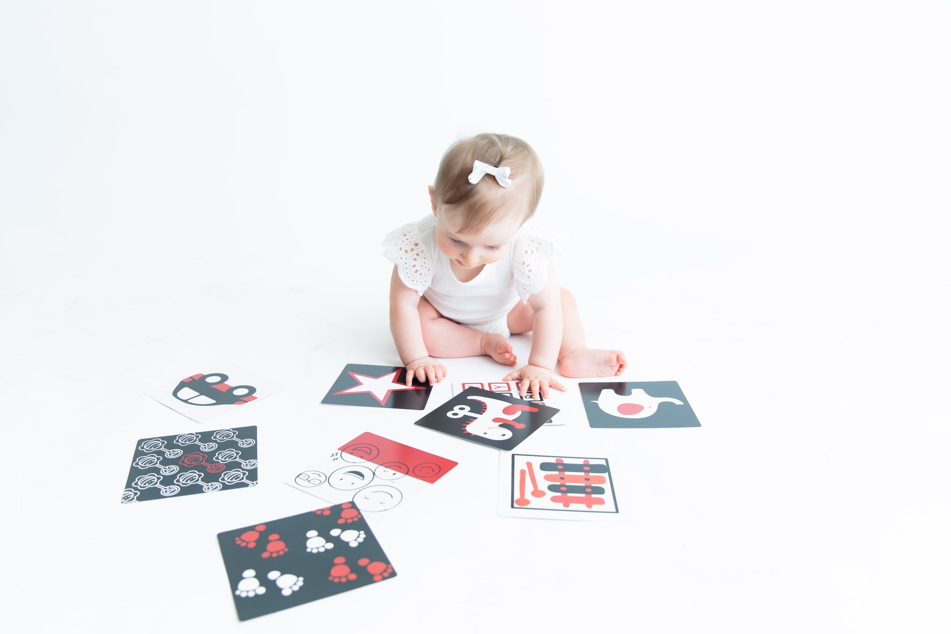 This little lady is excited to explore her baby vision flashcards designed to help with focus and attention. 