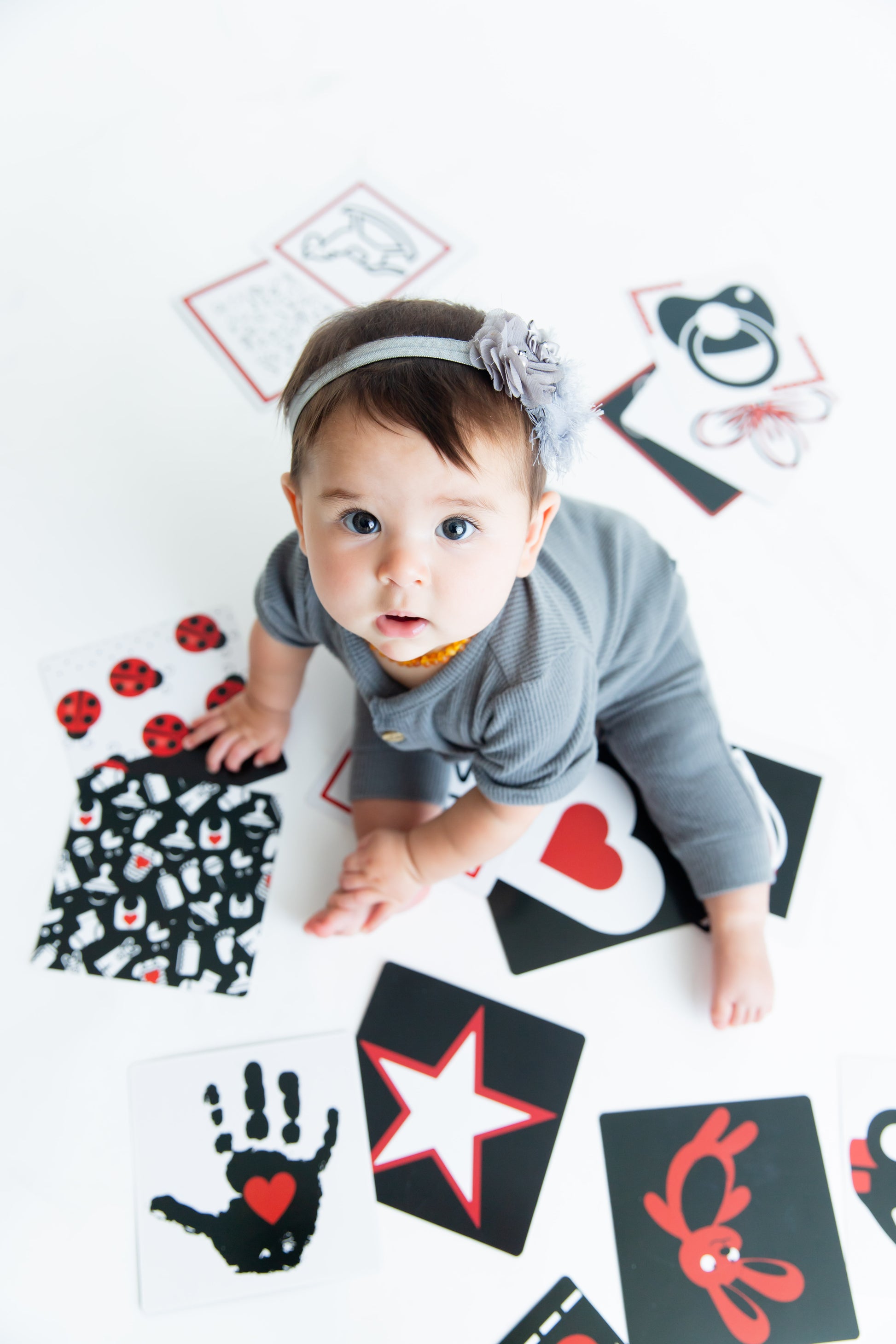 Our little lady is looking up while engaging with Baby Geometrics Flashcards which include high contrast designs for babies development. 
